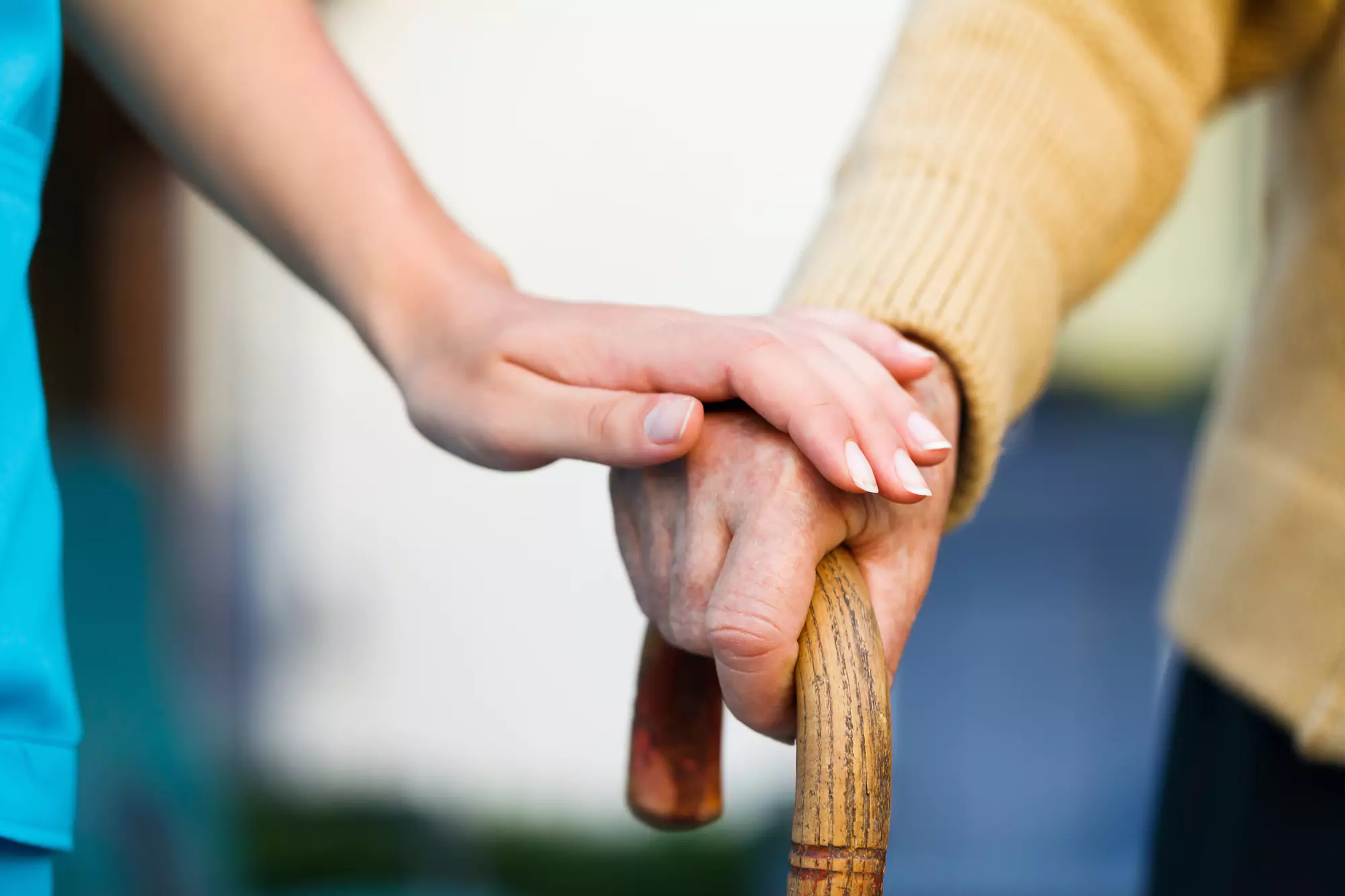 caregiver-holding-the-hand-of-an-elderly-patient