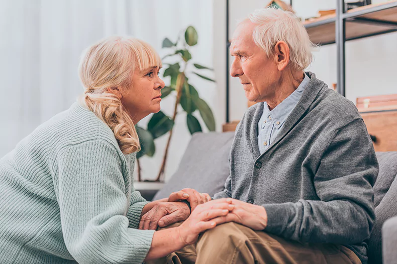 woman holding the hands of a loved one suffering from dementia.webp